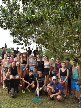 A group of young people volunteering in a tropical location.