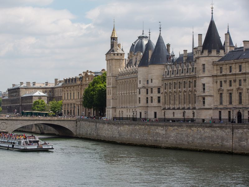 The historic Conciergerie building, located on the Seine River in Paris, France.