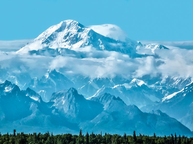 Majestic view of Denali (Mount McKinley) rising above the clouds in Alaska.