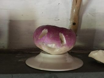 A carved turnip with a funny face.