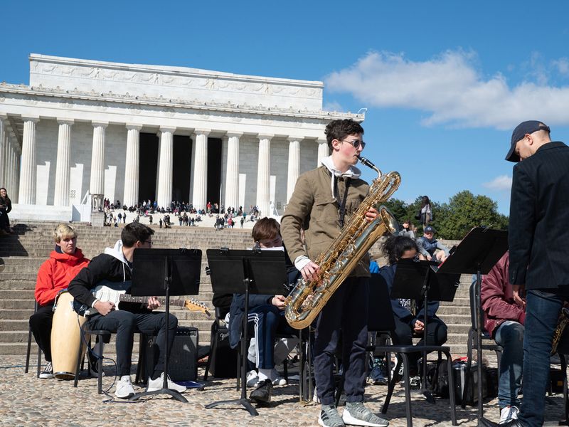 A high school jazz band playing in front of the Lincoln Memorial