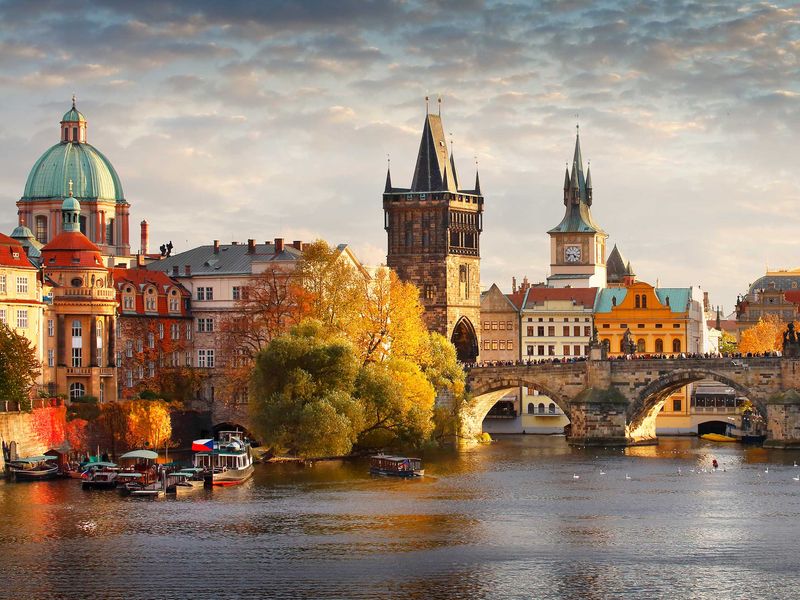 Charles Bridge in Prague during a beautiful autumn sunset.