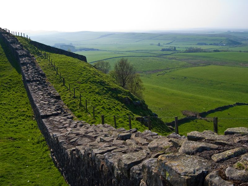 A view of Hadrian's Wall winding through the green hills of Northern England.