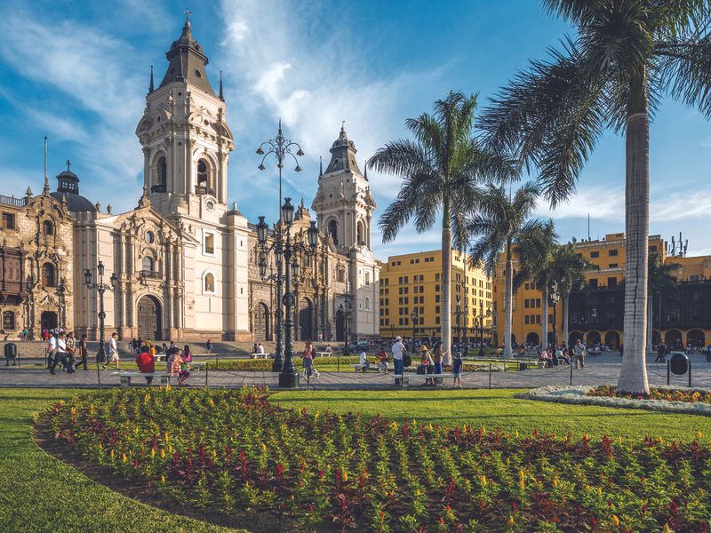 A sunny day at the Plaza Mayor in Lima, Peru, with people enjoying the square.