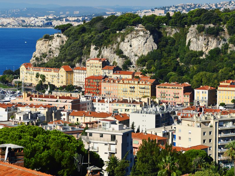 High-angle view of Nice, France, with its colorful buildings and the Mediterranean Sea in the background.