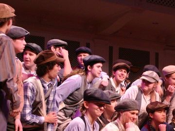 A group of teenagers performing a play on stage