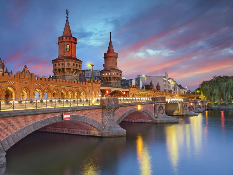 The Oberbaum Bridge illuminated at dusk in Berlin, Germany.