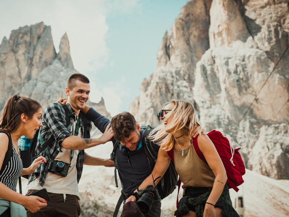 Five friends hiking together in the mountains