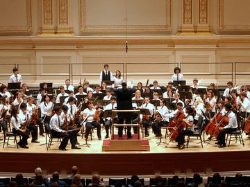 Youth orchestra performing in a concert hall