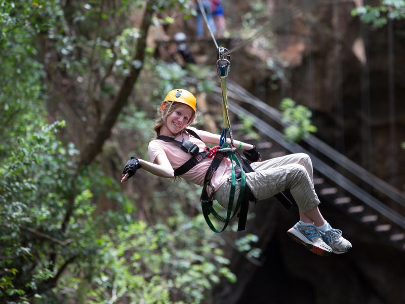 A child enjoys a rainforest zipline adventure.