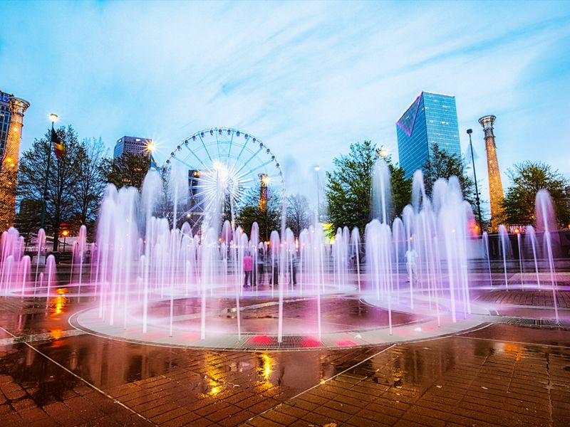 Centennial Olympic Park in Atlanta, Georgia, with the Ferris wheel and city skyline in the background.