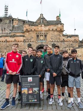 Group of teenage boys posing in front of Edinburgh Castle