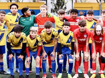 Group photo of a youth soccer team and their coaches.