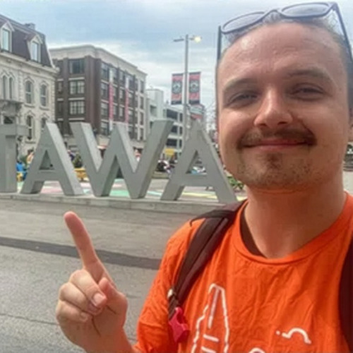 Man Posing with 'OTTAWA' Sign Tour Director