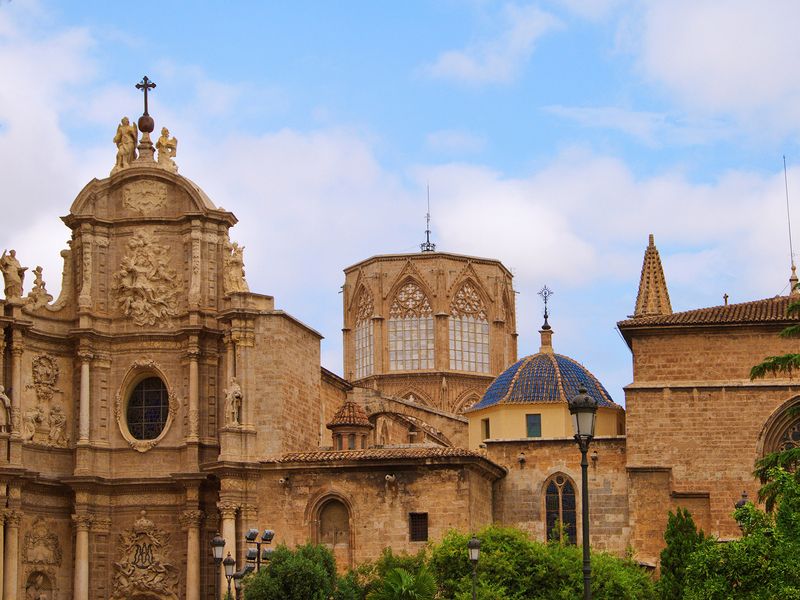 Valencia Cathedral under a blue sky with white clouds, in Valencia, Spain.