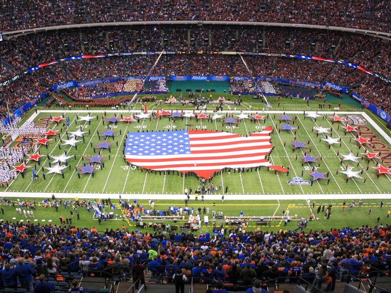 A giant American flag formed by people on a football field at Sugar Bowl in New Orleans