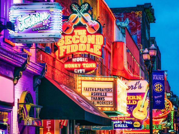 Nashville, Tennessee at dusk with the neon signs all lit up.