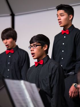 A choir of young men singing.