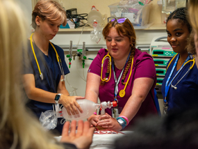 Nursing students perform life saving compressions