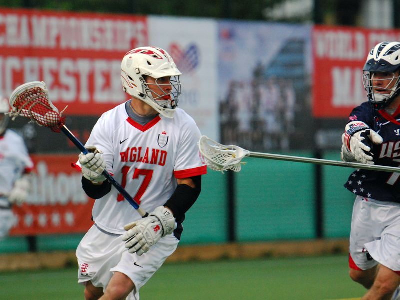 Two lacrosse players, one from England and one from the USA, compete in a game.