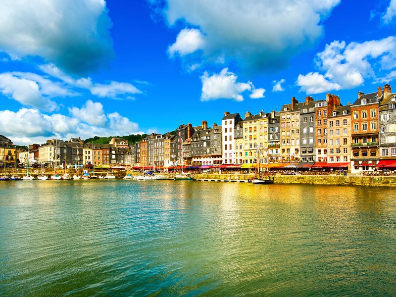 View of Honfleur harbor with colorful buildings and boats in Normandy, France.