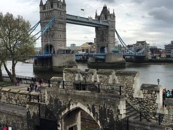 The Tower Bridge in London, England as seen on a cloudy day.