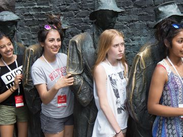 Group of teenagers pose with the statues at the Franklin Delano Roosevelt Memorial