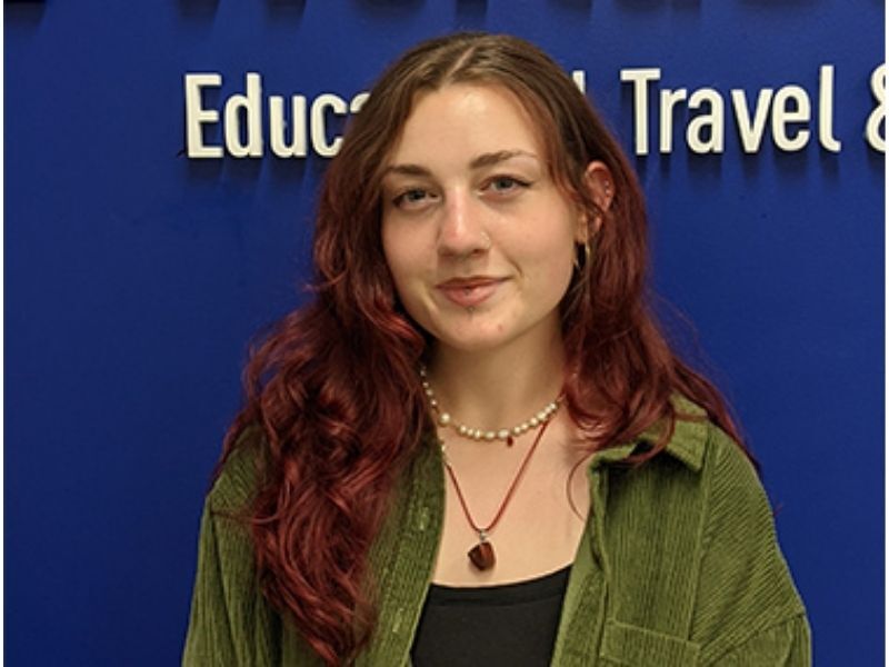 Portrait of a Young Woman Against a Blue Wall