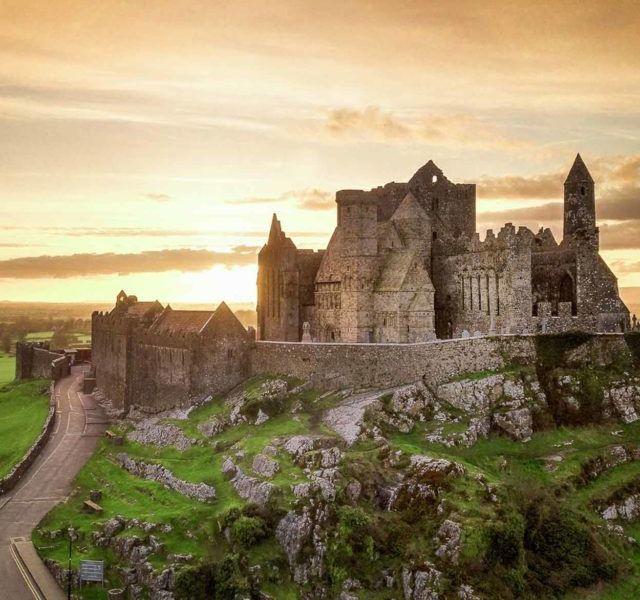 The Rock of Cashel at sunset, illuminated by the golden light.