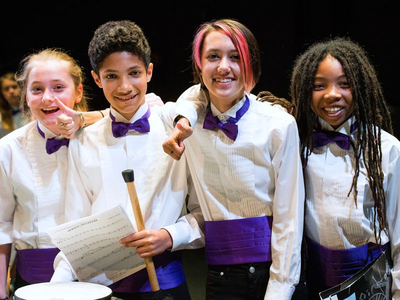 Group of teenage musicians in concert attire