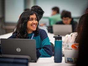 Smiling Young Woman with Laptop