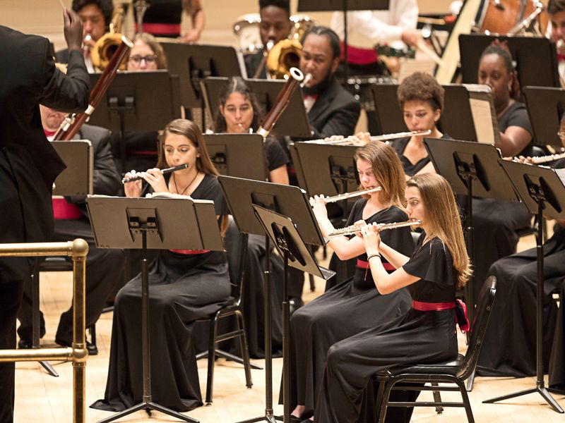 A high school youth orchestra performing a concert in Carnegie Hall