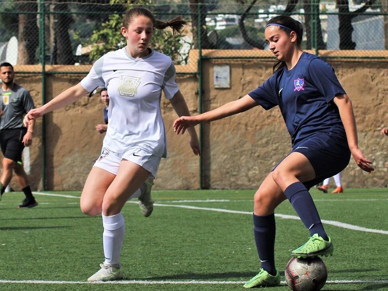 Two women playing in a soccer game