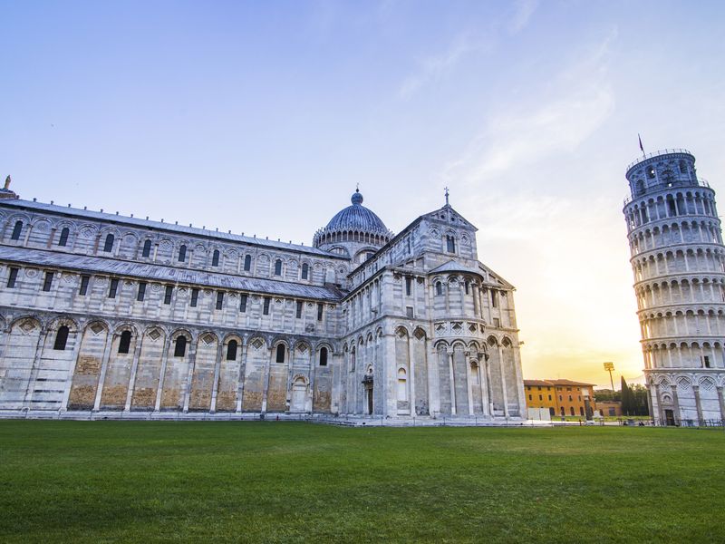 The Leaning Tower of Pisa and Pisa Cathedral at sunset.