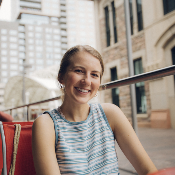 Smiling Young Woman on a City Patio