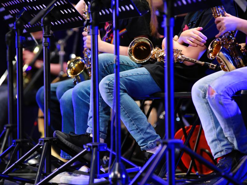 Group of young saxophone players on stage during a concert.