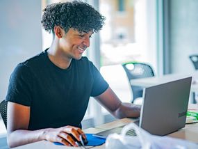 Young adult using laptop