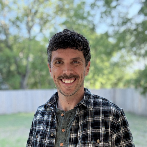 Smiling Man in Plaid Shirt
