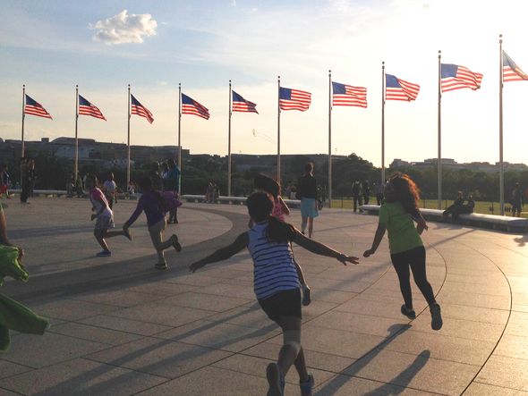 Children running and playing at the Washington Monument