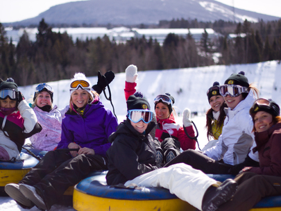 Friends Enjoying Winter Tubing Adventure