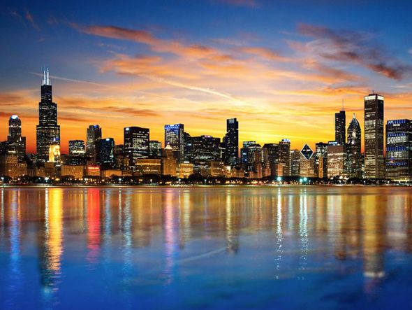 Chicago skyline at sunset with reflections in Lake Michigan