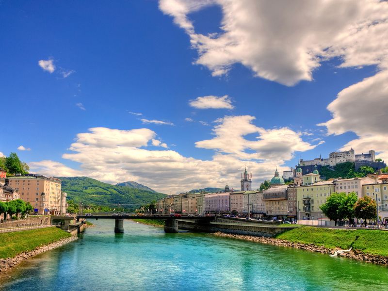 Scenic view of Salzburg with the Salzach River and Hohensalzburg Fortress in the background.