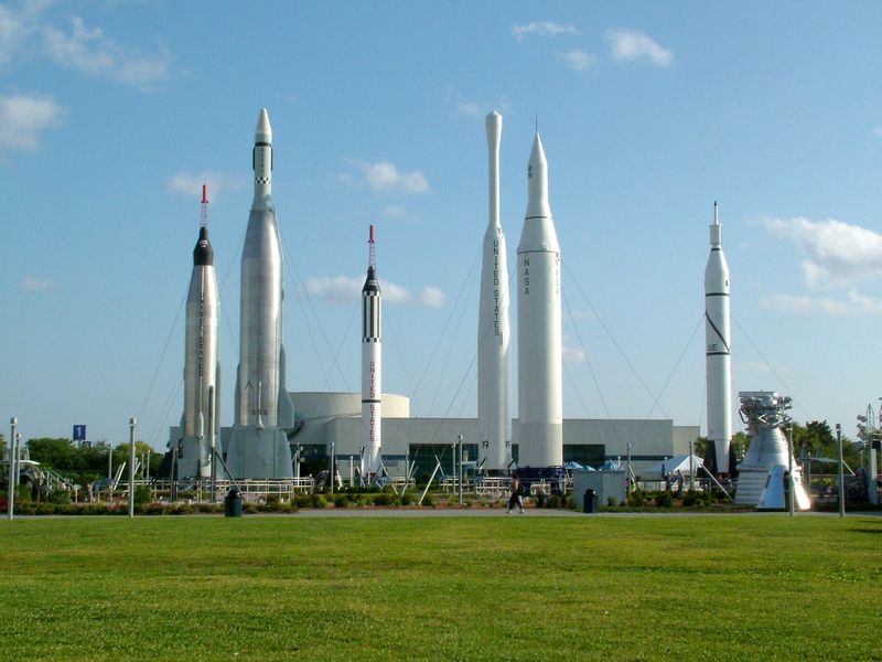 A row of rockets on display at a space center.