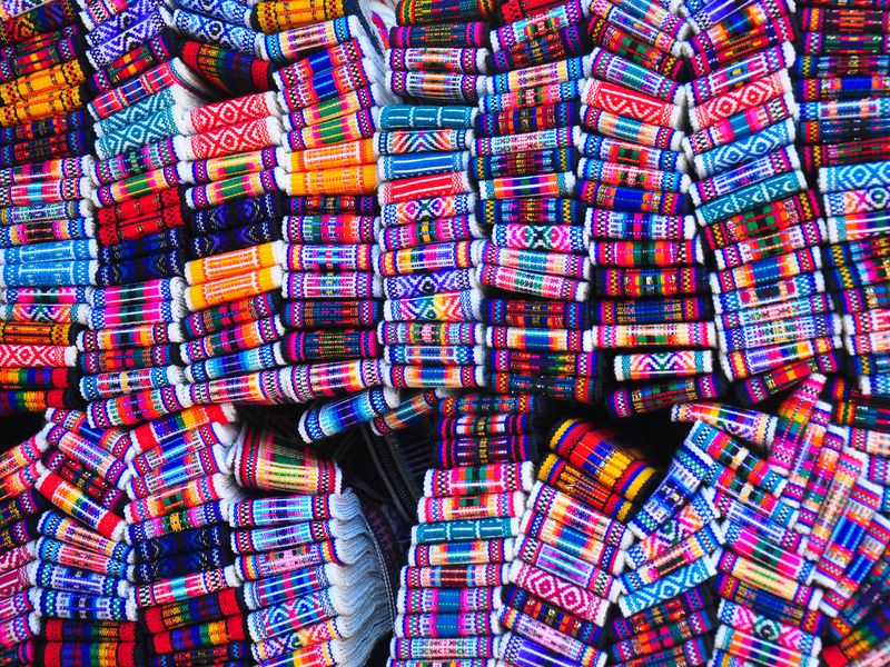 Close-up of a collection of vibrant, woven textiles.