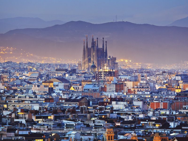 City view of Barcelona with the Sagrada Familia in the center at dusk.