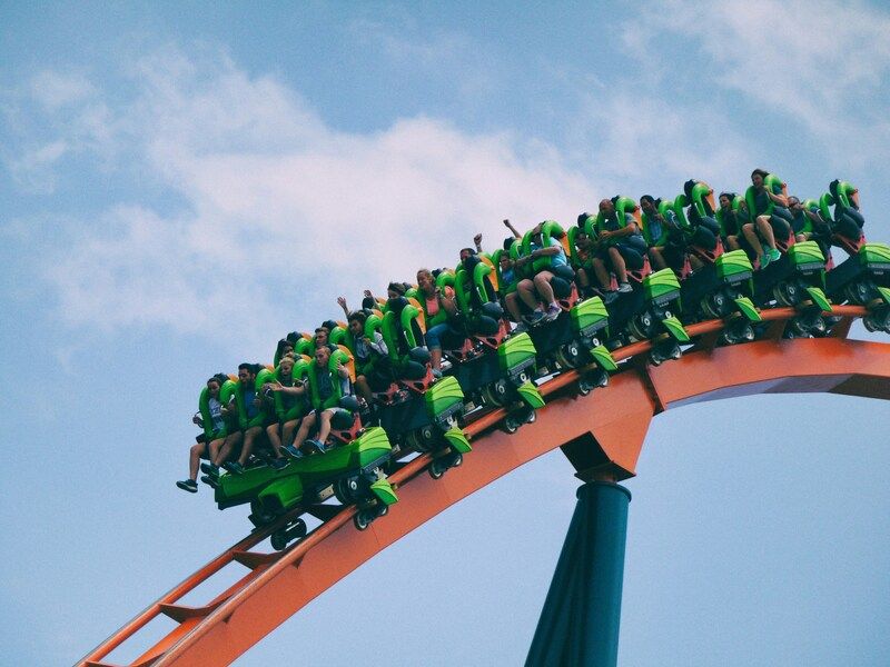 A group of people riding a roller coaster.