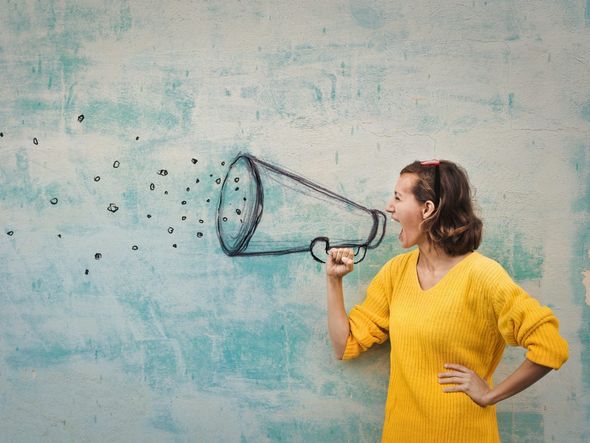 Woman shouting into a megaphone drawn on a wall.