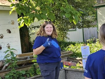 Group of young adults volunteering in a community garden.