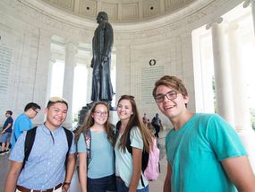 Four teenagers taking a selfie at the Jefferson Memorial