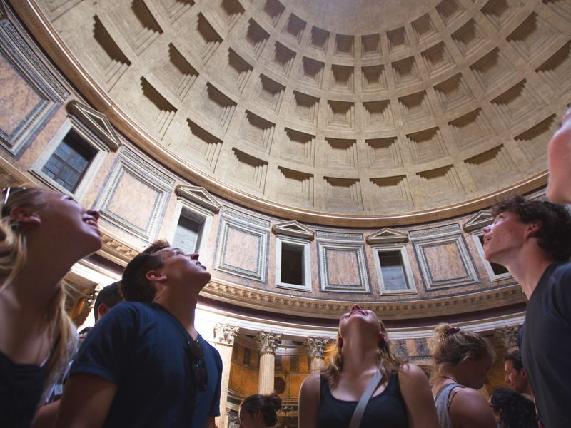 Young adults marvel at the Pantheon's dome in Rome.